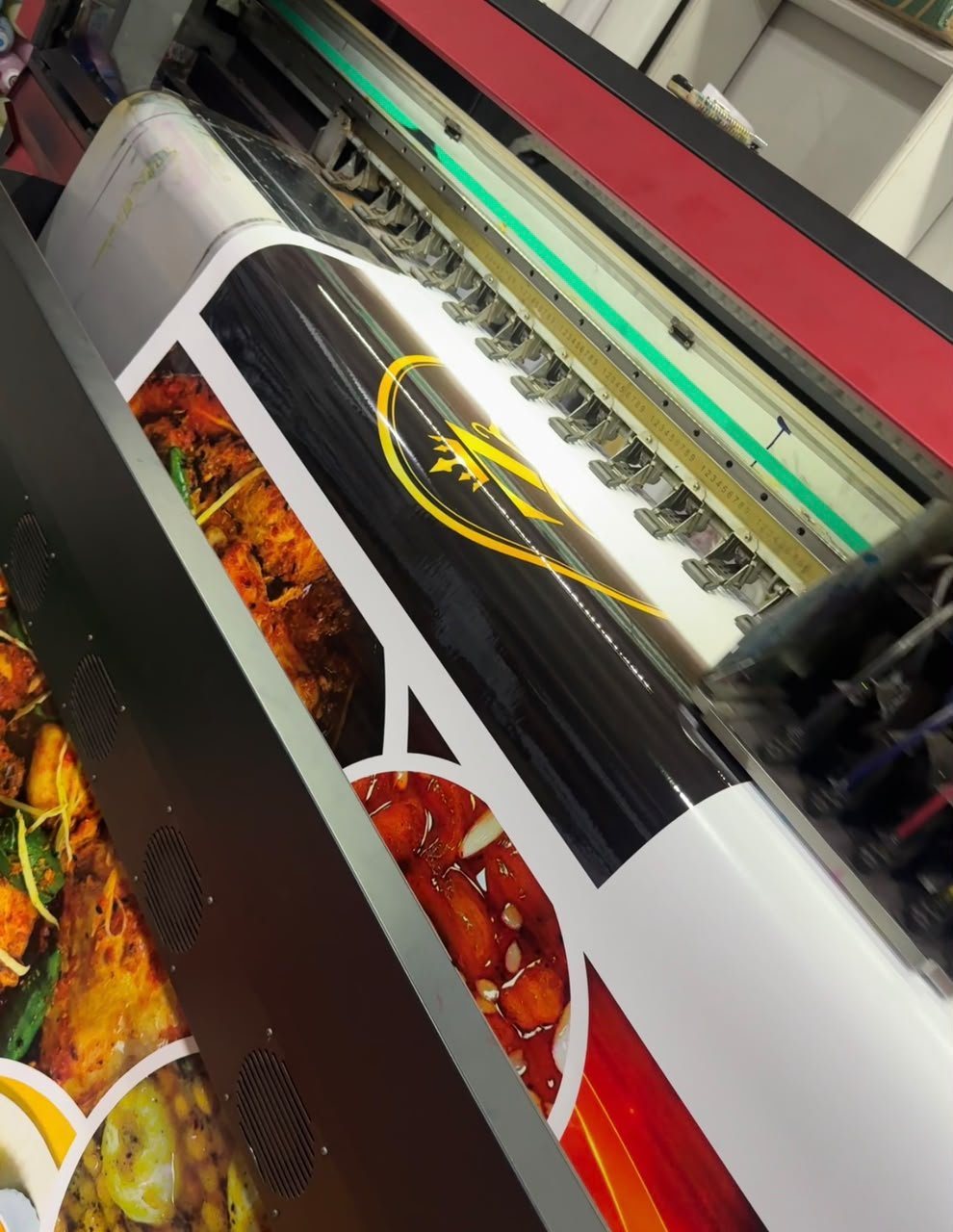 Large-format printer printing a vinyl food banner at PRINT POINT